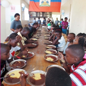 Children receive meals through Haitian Educational Initiates feeding program.