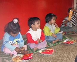 Children receive a treat from out-of-town visitors (the David Fletcher family) at HOPE worldwide orphanage in New Delhi.