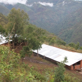A VHW building under construction in the mountains of Kigutu.