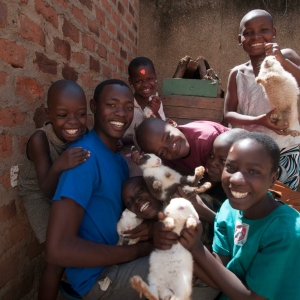Davis and the kids show the rabbits they rear for extra income