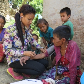 A Possible nurse working with patients in Nepal.
